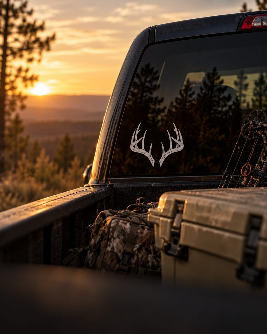 Deer antler decal on a truck window at sunset - Hunt One More hunting decals